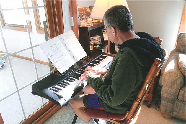 Dave Nimmer practices Amazing Grace at his new keyboard.